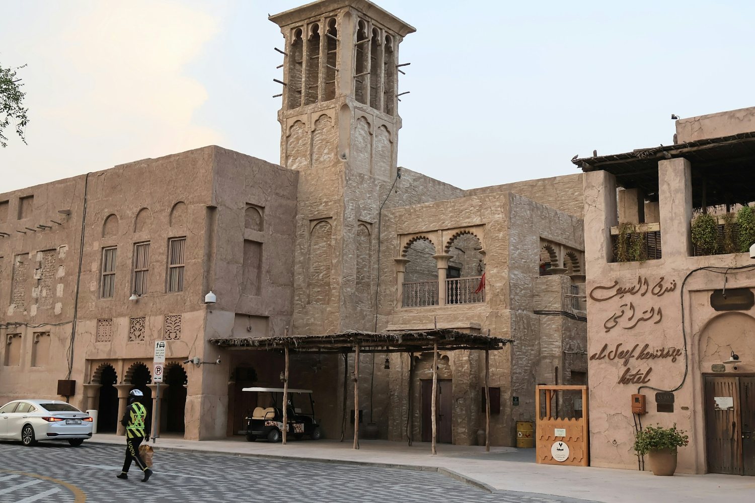 A wind tower and stone street at Al Seef