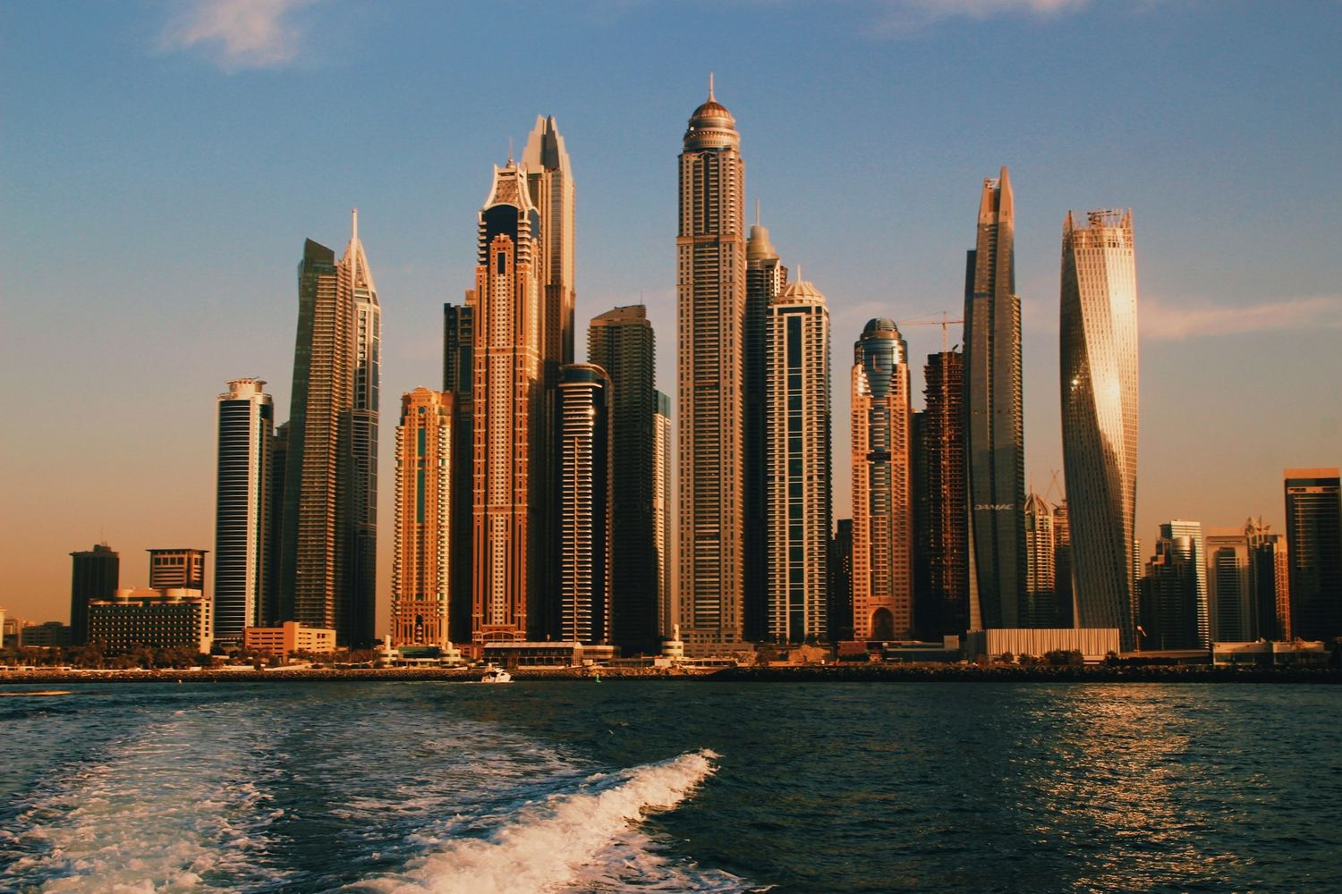 The Dubai Marina towers seen from the water in evening light